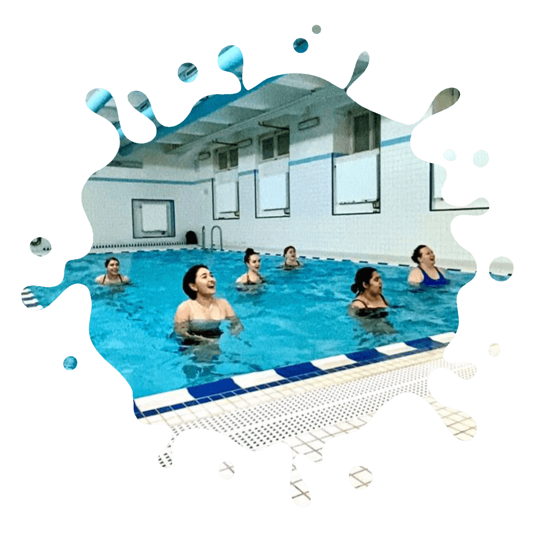 A group of people in an indoor swimming pool.
